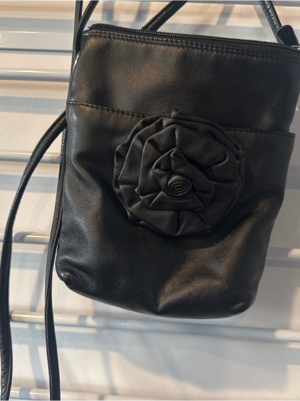 Sleek Black Crossbody Bag with Rosette Accent